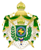 Coat of arms consisting of a shield with a green field with a golden armillary sphere superimposed on the red and white Cross of the Order of Christ, surrounded by a blue band with 20 silver stars; the bearers are two arms of a wreath, with a coffee branch on the left and a flowering tobacco branch on the right; and above the shield is an arched golden and jeweled crown